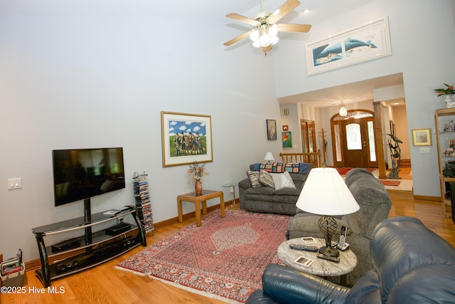 17 Troon Dr, Pinehurst, NC 28374 - living room featuring wood finished floors, a ceiling fan, a towering ceiling, and baseboards