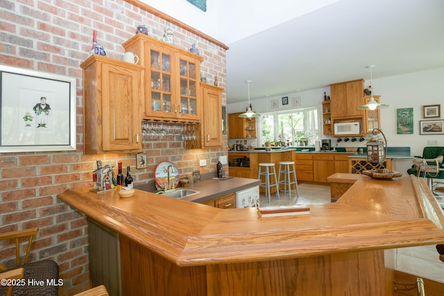 17 Troon Dr, Pinehurst, NC 28374 - indoor bar featuring white microwave, backsplash, and decorative light fixtures