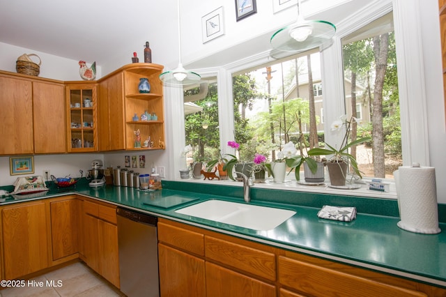 17 Troon Dr, Pinehurst, NC 28374 - kitchen featuring stainless steel dishwasher, a sink, glass insert cabinets, and brown cabinetry
