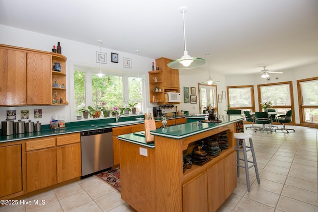 17 Troon Dr, Pinehurst, NC 28374 - kitchen with open shelves, dishwasher, white microwave, a kitchen island, and light tile patterned floors