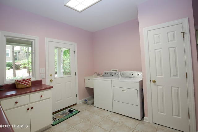 17 Troon Dr, Pinehurst, NC 28374 - washroom featuring washer and clothes dryer, cabinet space, baseboards, and light tile patterned flooring