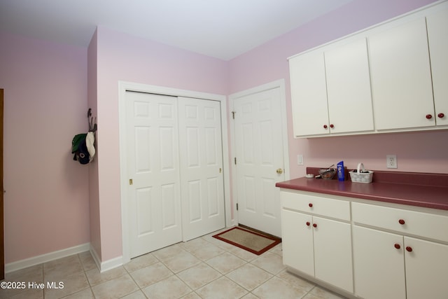 17 Troon Dr, Pinehurst, NC 28374 - kitchen featuring dark countertops, white cabinetry, light tile patterned floors, and baseboards