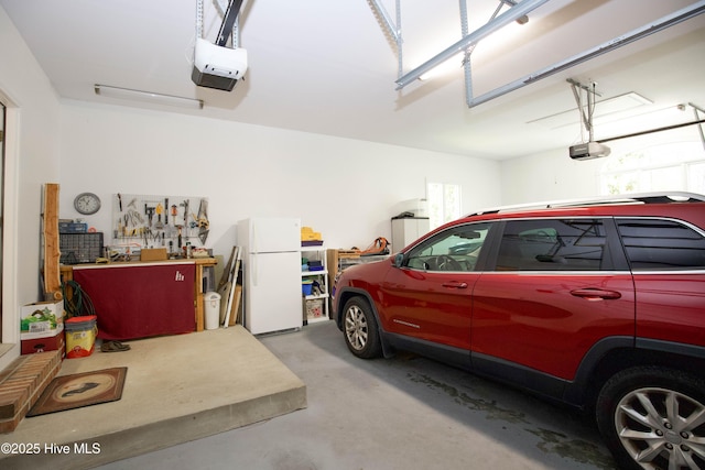17 Troon Dr, Pinehurst, NC 28374 - garage with freestanding refrigerator, a garage door opener, and a workshop area