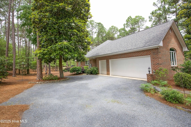 17 Troon Dr, Pinehurst, NC 28374 - view of front of house featuring a shingled roof, brick siding, driveway, and a garage