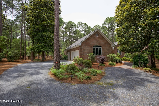 17 Troon Dr, Pinehurst, NC 28374 - view of front facade featuring brick siding, a garage, and driveway
