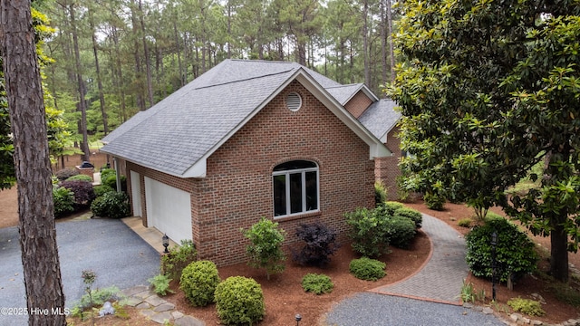 17 Troon Dr, Pinehurst, NC 28374 - view of side of property featuring brick siding, roof with shingles, and asphalt driveway