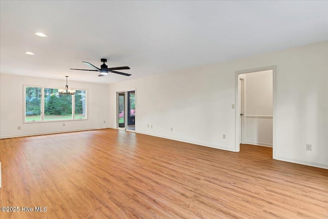 spare room with light wood-type flooring, a chandelier, baseboards, recessed lighting, and a ceiling fan