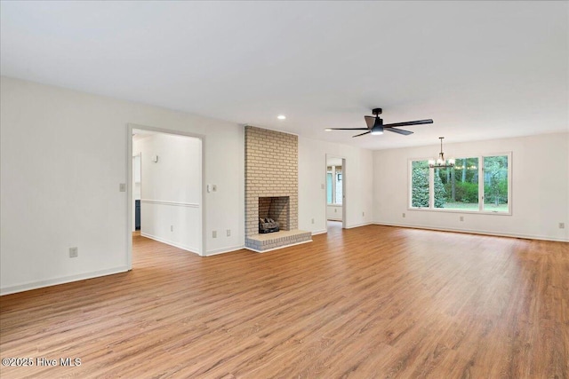 unfurnished living room featuring a chandelier, light wood-style flooring, baseboards, and recessed lighting