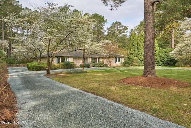 view of front of home with driveway and a front yard