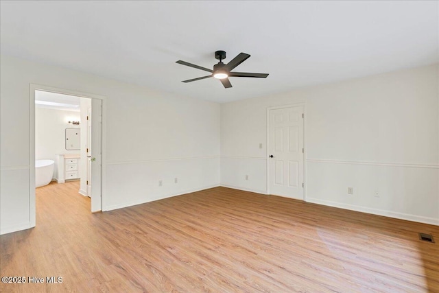 unfurnished room featuring light wood finished floors, ceiling fan, and baseboards