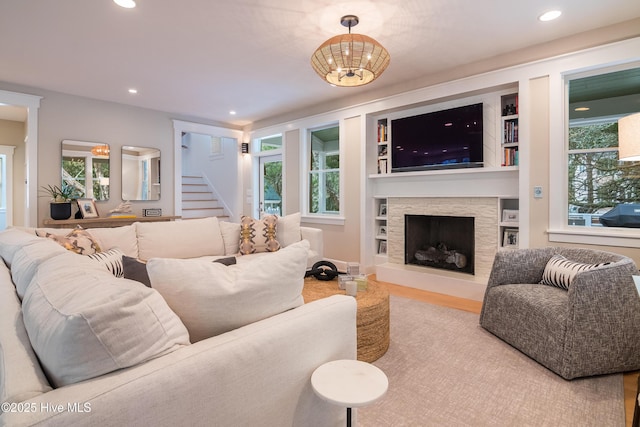 3 Sabal Palm Trl, Bald Head Island, NC 28461 - living room with wood finished floors, stairs, a stone fireplace, and recessed lighting