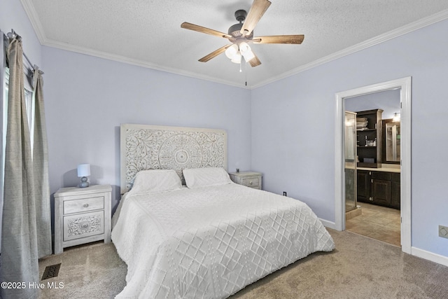 carpeted bedroom with ornamental molding, ensuite bathroom, a textured ceiling, baseboards, and ceiling fan