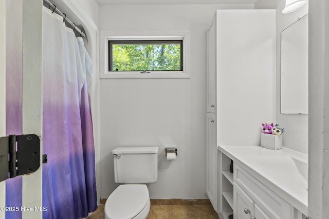 full bath featuring vanity, toilet, tile patterned flooring, and baseboards