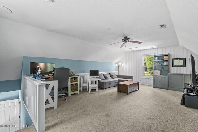 office area featuring lofted ceiling, carpet flooring, a textured ceiling, and a ceiling fan
