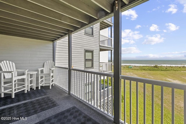 balcony with view of water and beach