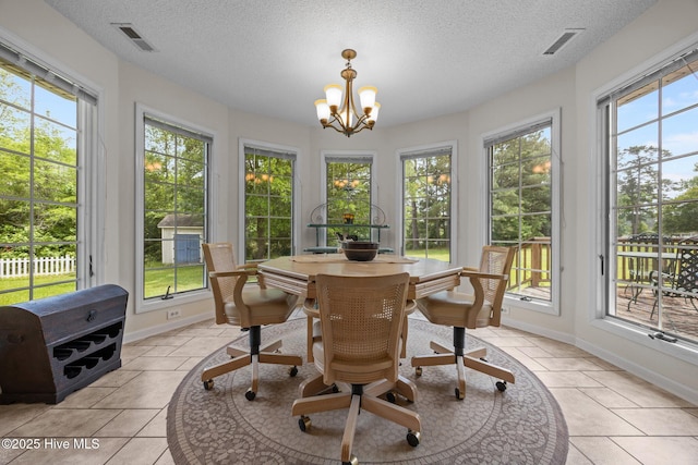 9333 Doris Dr, Oriental, NC 28571 - sunroom with baseboards, a textured ceiling, a chandelier, and tile patterned floors
