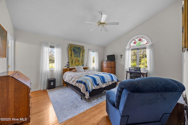 9333 Doris Dr, Oriental, NC 28571 - bedroom featuring light wood-style floors, lofted ceiling, ceiling fan, and a textured ceiling