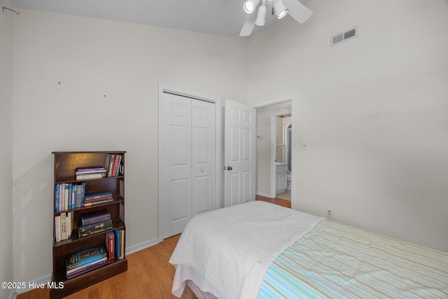 9333 Doris Dr, Oriental, NC 28571 - bedroom with a closet, wood finished floors, baseboards, ceiling fan, and a towering ceiling