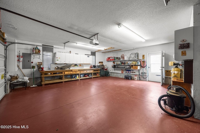 9333 Doris Dr, Oriental, NC 28571 - garage featuring electric panel, a workshop area, and a garage door opener