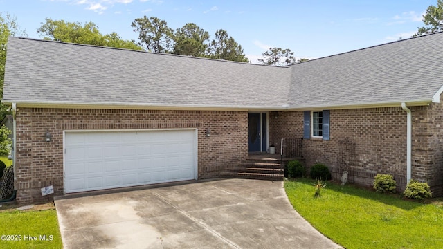 9333 Doris Dr, Oriental, NC 28571 - ranch-style house featuring concrete driveway, a shingled roof, brick siding, an attached garage, and a front yard