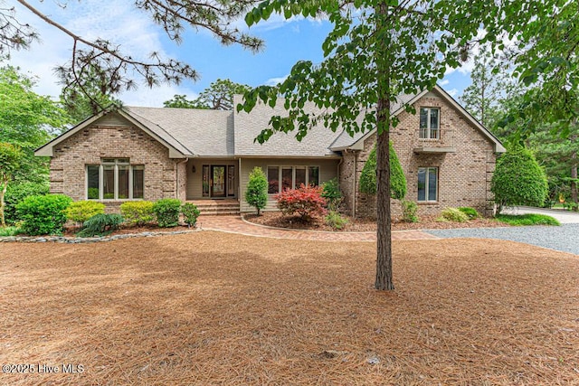20 Shenecossett Ln, Pinehurst, NC 28374 - view of front of property featuring brick siding and a shingled roof