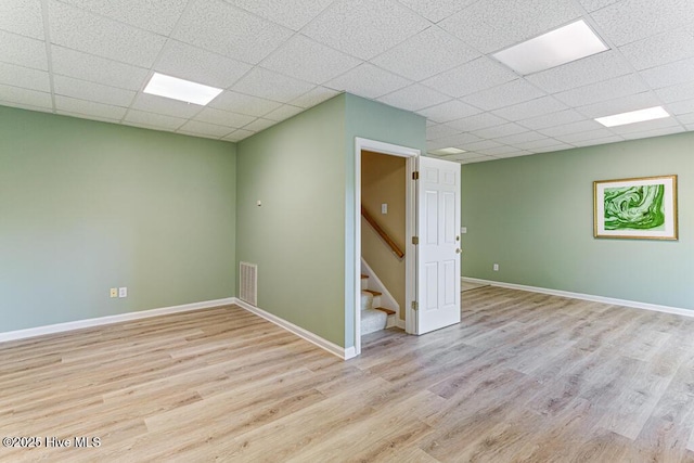 20 Shenecossett Ln, Pinehurst, NC 28374 - spare room with wood finished floors, stairway, a paneled ceiling, and baseboards
