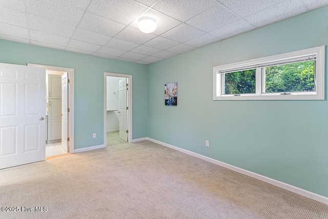 20 Shenecossett Ln, Pinehurst, NC 28374 - unfurnished bedroom featuring carpet, baseboards, a paneled ceiling, a walk in closet, and ensuite bath