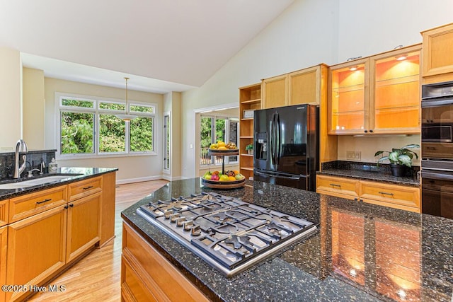 20 Shenecossett Ln, Pinehurst, NC 28374 - kitchen featuring black appliances, a sink, light wood-style floors, glass insert cabinets, and dark stone counters