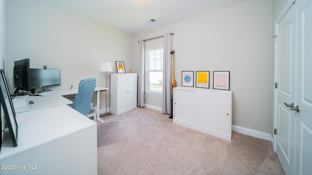 home office featuring light carpet and baseboards