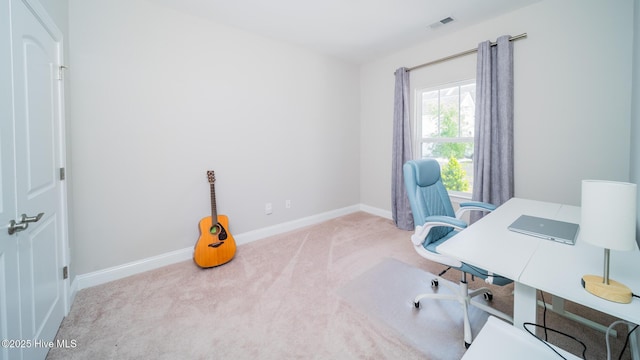 carpeted home office featuring baseboards