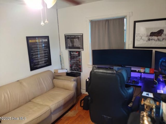 home office with a ceiling fan and wood finished floors