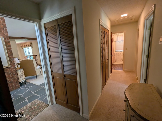 hall with carpet flooring and baseboards