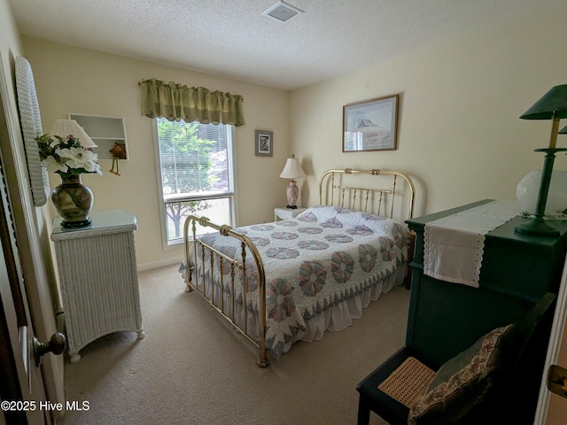 bedroom featuring carpet and a textured ceiling