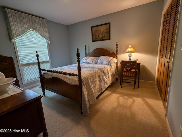 bedroom with light carpet and baseboards