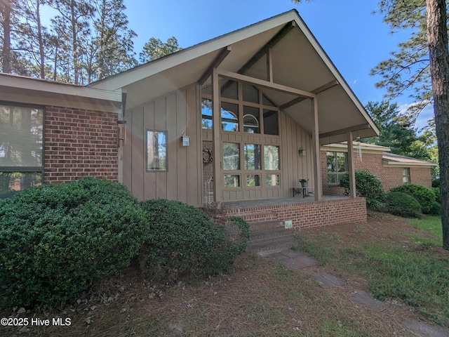property entrance with board and batten siding and a porch
