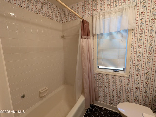 full bathroom with wallpapered walls, shower / bath combo with shower curtain, toilet, baseboards, and tile patterned flooring