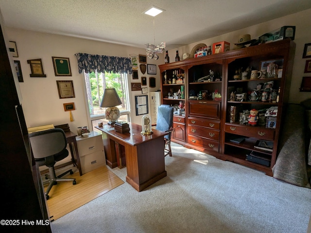 office with carpet floors, a textured ceiling, and a chandelier