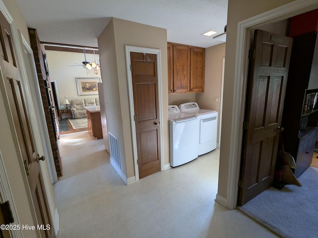 laundry area with washer and dryer, cabinet space, and baseboards
