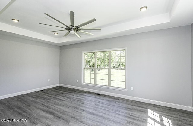 131 Putters Ln, Pinetops, NC 27864 - spare room with a raised ceiling, dark wood finished floors, baseboards, a ceiling fan, and recessed lighting