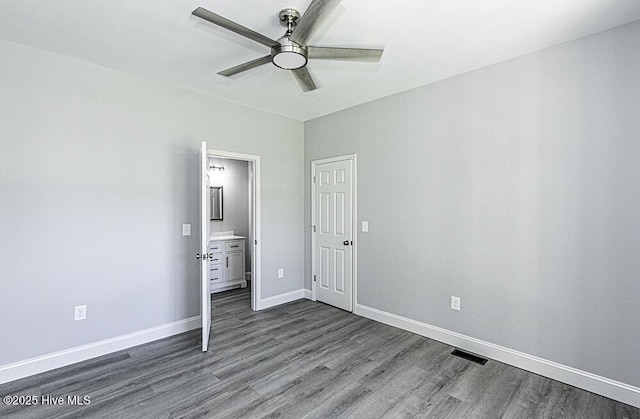 131 Putters Ln, Pinetops, NC 27864 - unfurnished bedroom featuring dark wood-style floors, baseboards, ensuite bath, and a ceiling fan