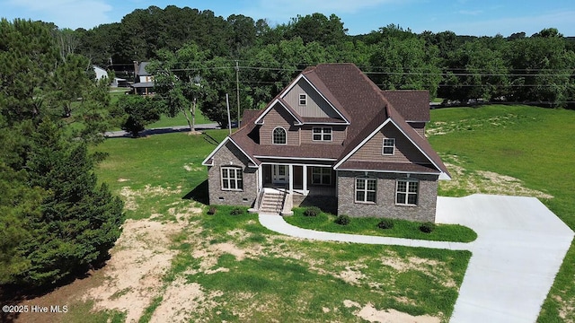 131 Putters Ln, Pinetops, NC 27864 - view of front of property featuring a porch, a forest view, concrete driveway, and a front yard
