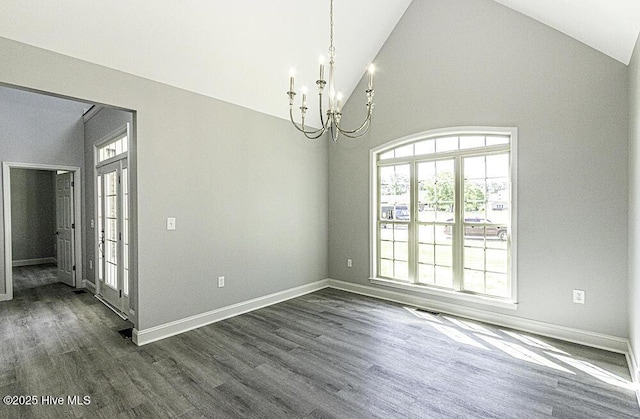 131 Putters Ln, Pinetops, NC 27864 - spare room with a chandelier, dark wood-style floors, vaulted ceiling, and baseboards