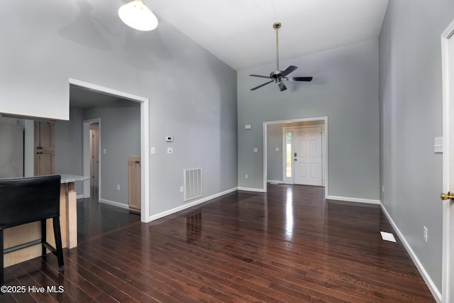 107 Live Oak Ct, Pine Knoll Shores, NC 28512 - unfurnished living room with ceiling fan, high vaulted ceiling, dark wood-style floors, and baseboards