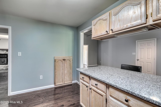 107 Live Oak Ct, Pine Knoll Shores, NC 28512 - kitchen with dark wood-style flooring, light brown cabinetry, baseboards, and light stone countertops