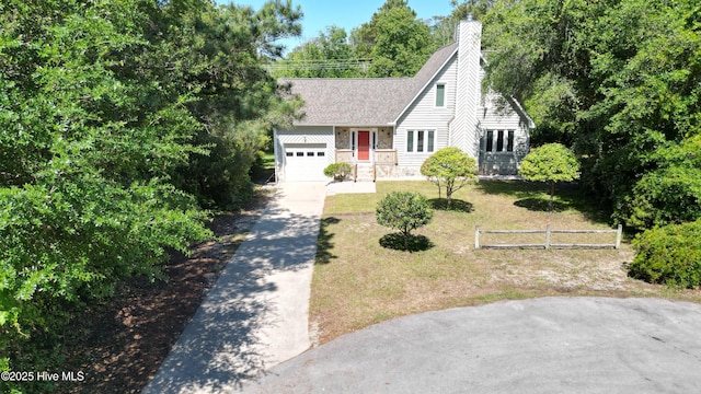 107 Live Oak Ct, Pine Knoll Shores, NC 28512 - view of front of property featuring concrete driveway, a garage, a chimney, and roof with shingles