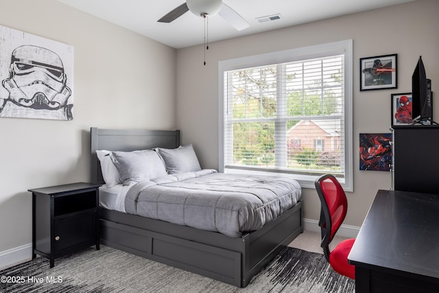 carpeted bedroom with baseboards and a ceiling fan