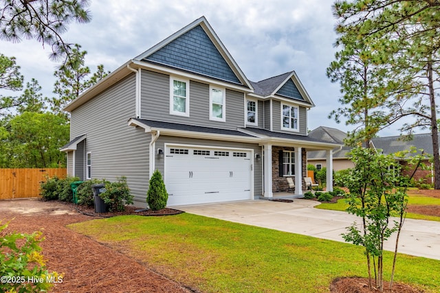 craftsman-style house featuring covered porch, driveway, and an attached garage