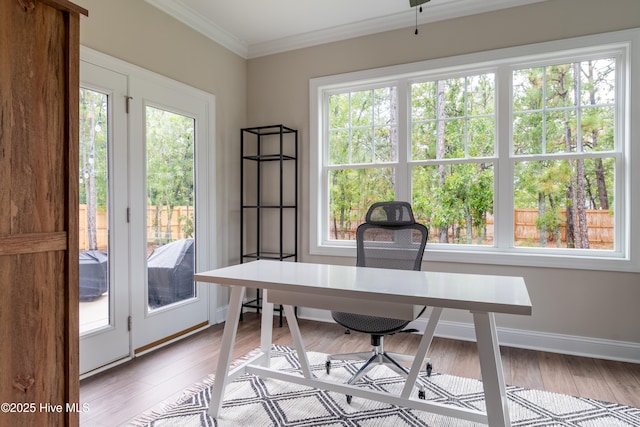 office area with ornamental molding, light wood finished floors, and baseboards