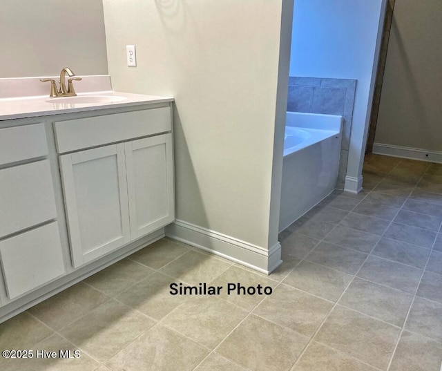 754 Secession Ln, Jacksonville, NC 28546 - bathroom with tile patterned flooring, a bath, baseboards, and vanity