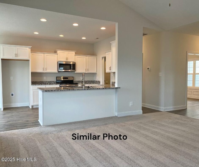 754 Secession Ln, Jacksonville, NC 28546 - kitchen with appliances with stainless steel finishes, white cabinetry, dark stone counters, recessed lighting, and baseboards